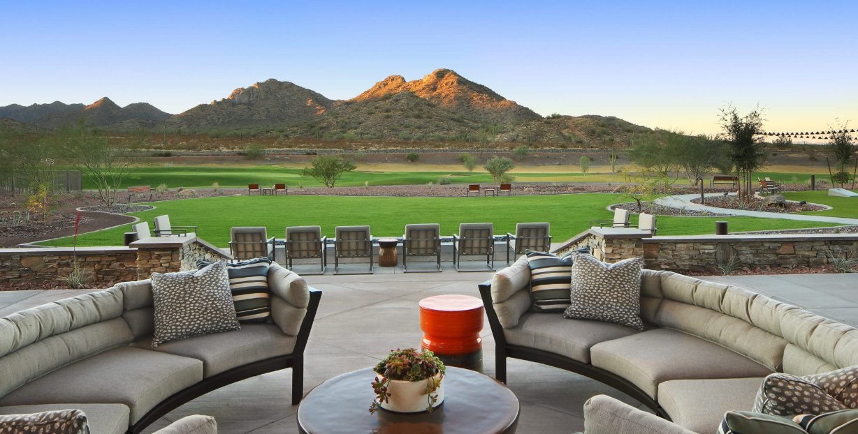Outdoor resort lounge seating overlooking the Copper Canyon golf course and mountains at Sun City Festival in Buckeye, Arizona
