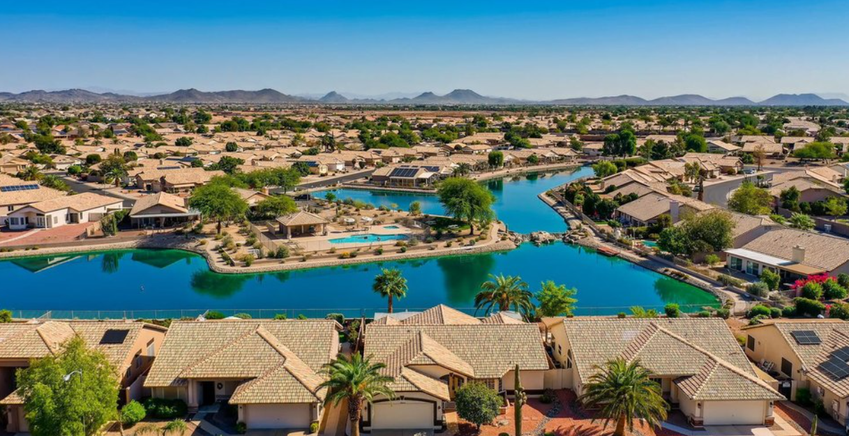 Aerial view of the turquoise lakes and tile-roof homes at Ventana Lakes in Peoria, Arizona